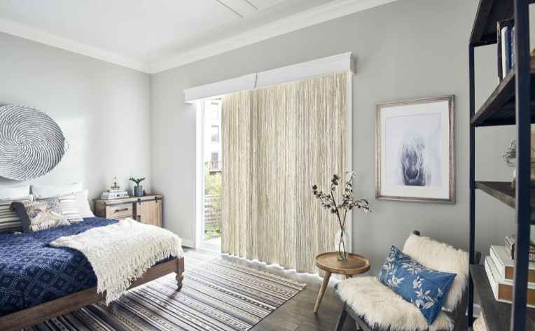 white natural drapes in bedroom with blue accents