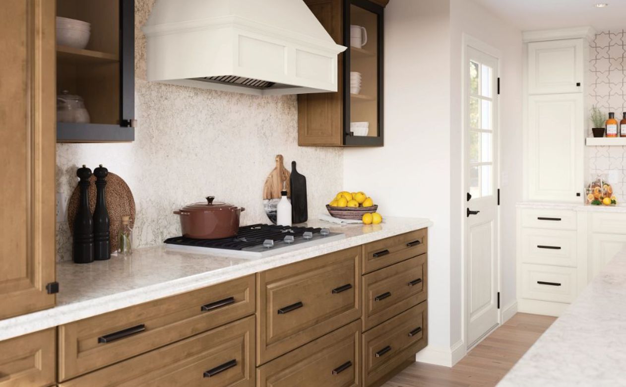 matte black cabinet hardware in a stylish kitchen with wood cabinets, tile backsplash, and range hood from Kiba Studios Houston