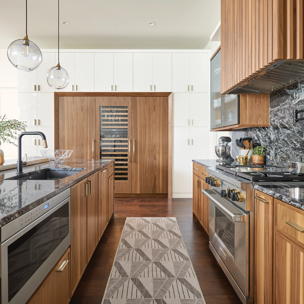 Kitchen with wood cabinetry and black marble countertops
