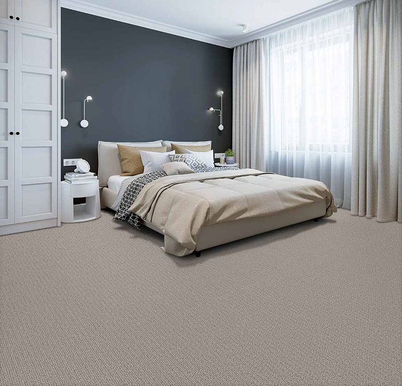 Modern 2020 bedroom designed with a minimalism technique and neutral colors to include a slate grey wall and beige carpet.