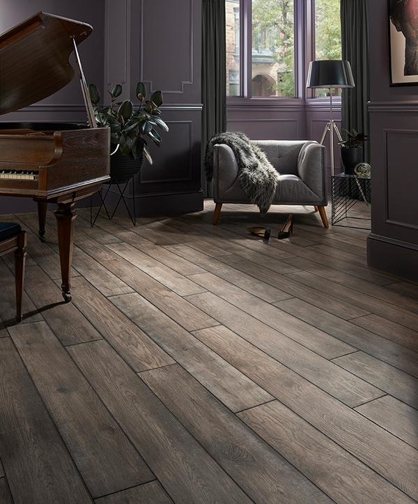 A picture highlighting a 2020 themed luxury vinyl tile flooring design that incorporates a dark wood look.