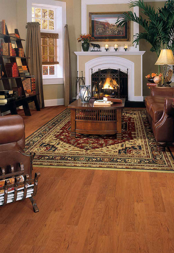 Family room with cozy fireplace, plush leather furniture, large area rug, and lamps providing soft lighting.