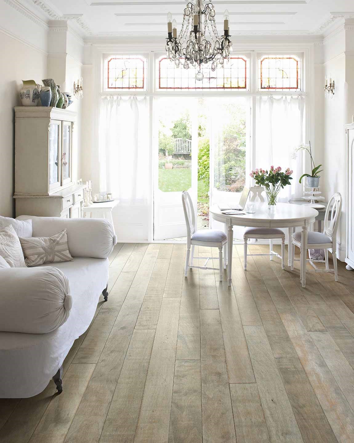 bright living room with white furniture light hardwood floors