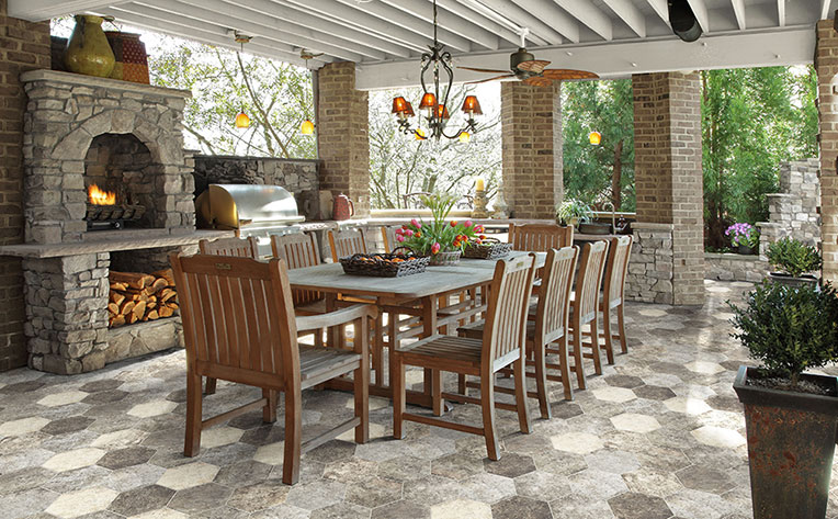 Outdoor covered dining space with stone fireplace