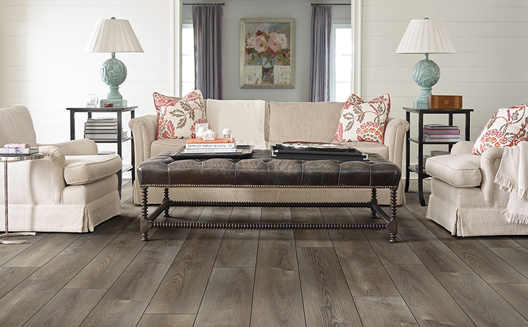 Beach inspired living room with distressed light brown luxury vinyl plank floors