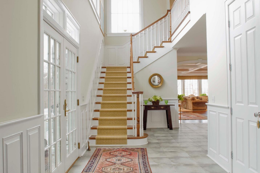 home entrance facing inside home with carpet lined staircase