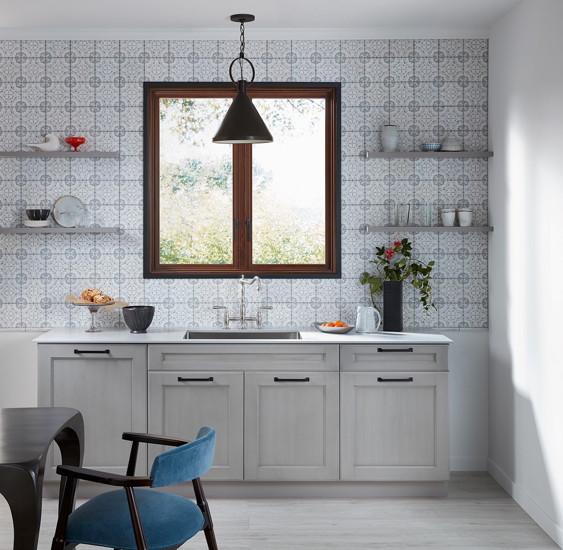 kitchen sink and counter with patterned back splash 