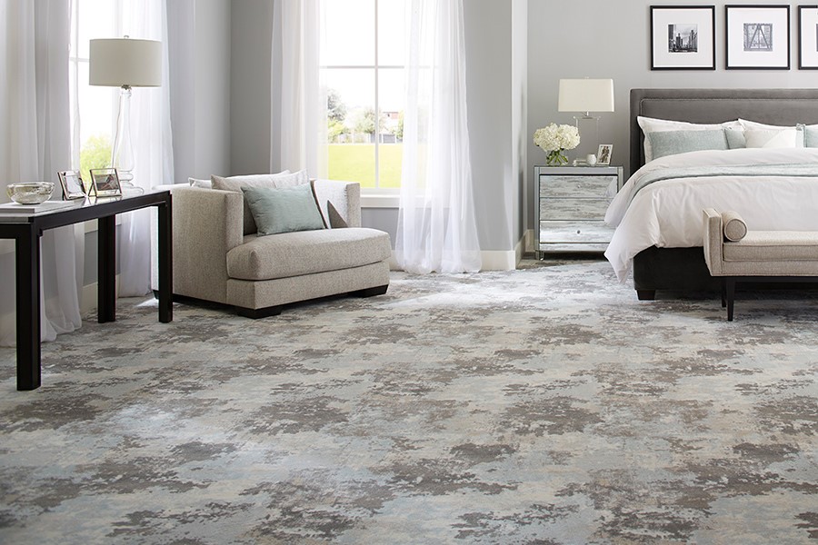light colored master bedroom with distressed carpet