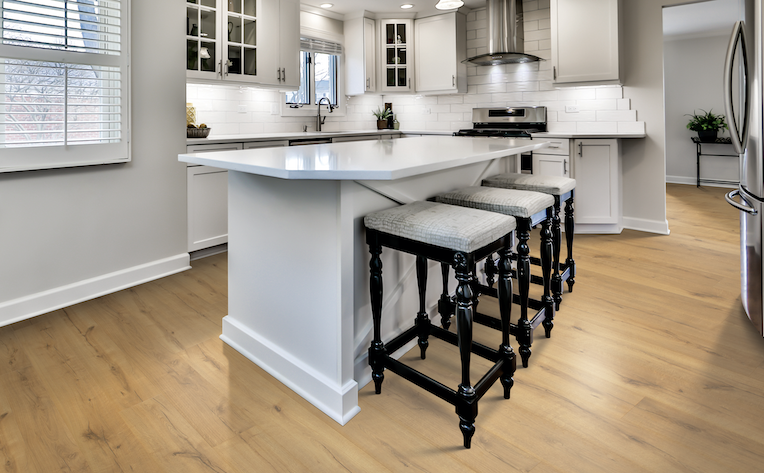 warm light toned laminate flooring in a stylish white kitchen