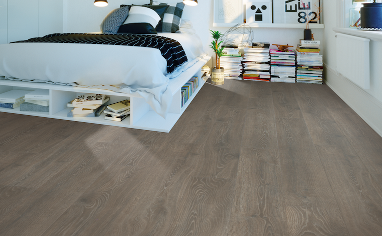 wide plank wood look laminate flooring in a bedroom
